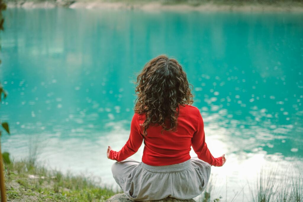 A woman meditating in the middle of a lake