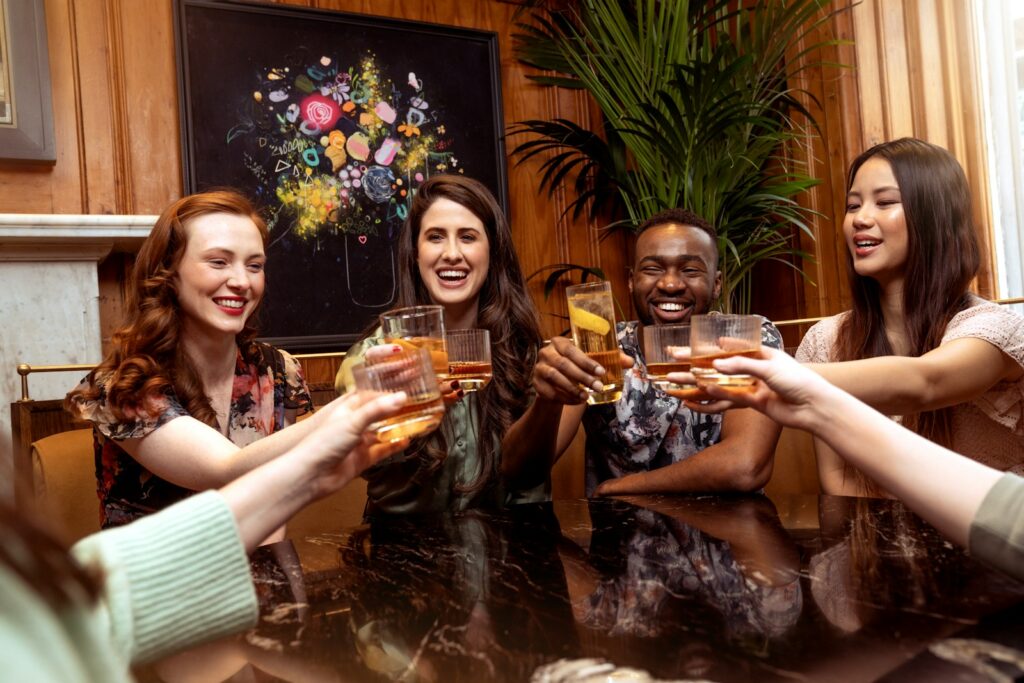 a group of people sitting around a table toasting